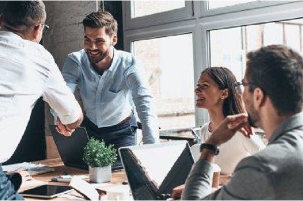 man greeting office colleague